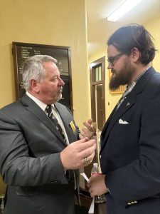The candidate receives his Grand Master's pin from... the Grand Master!