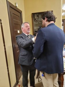 The candidate receives his Grand Master's pin from... the Grand Master!